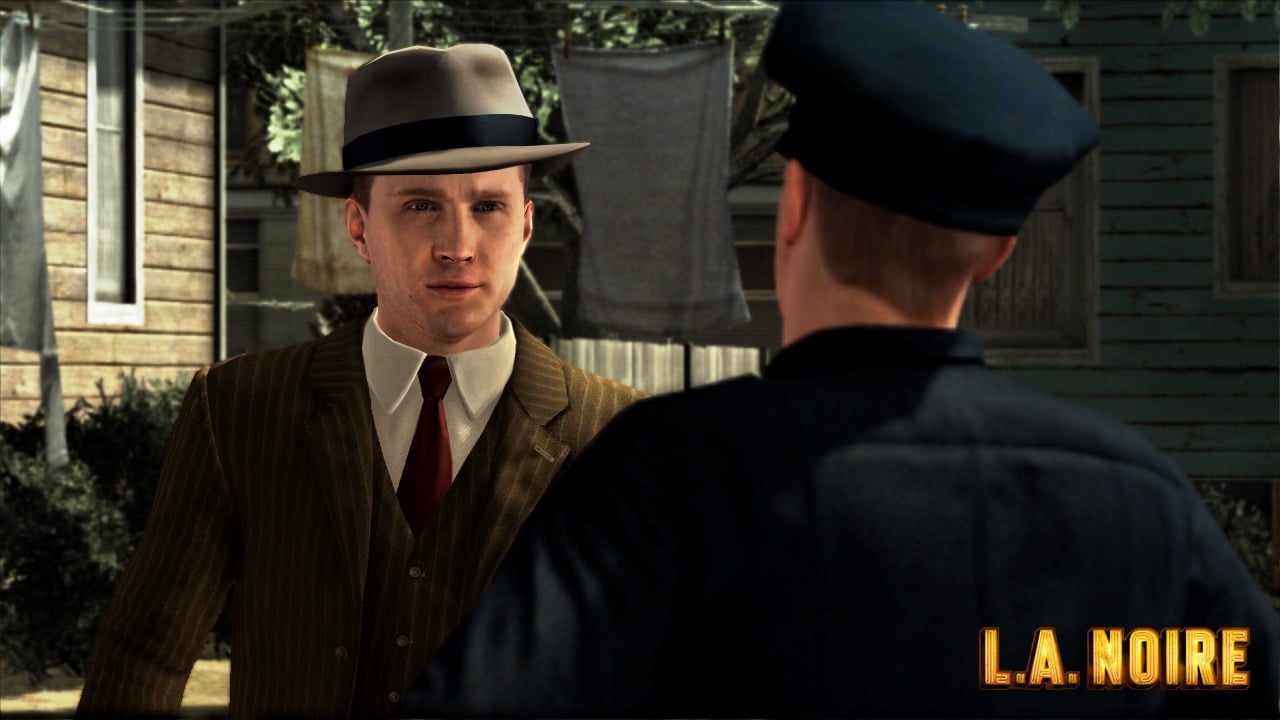 Official L.A. Noire screenshot showing Cole Phelps talking to a police officer.