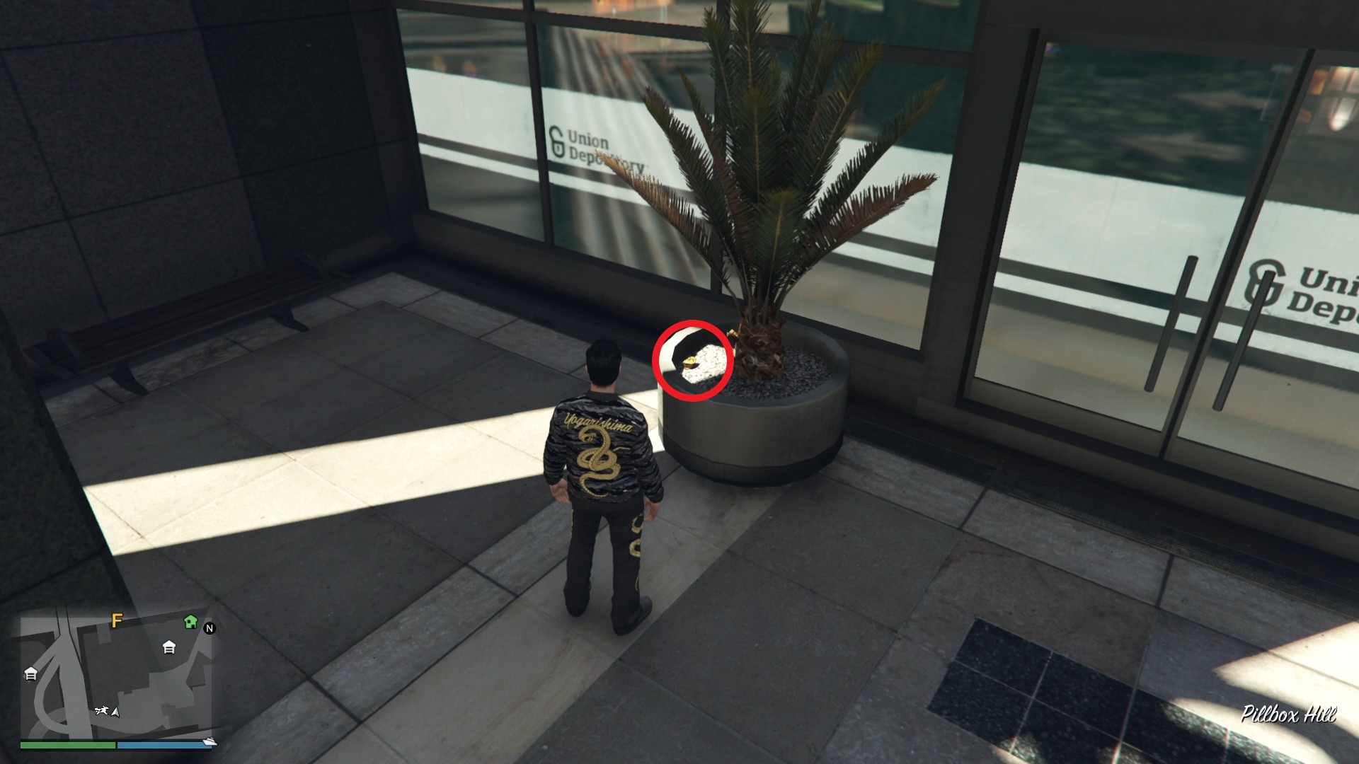 The Yuanbao is inside a plant pot on the left side of the Union Depository entrance.