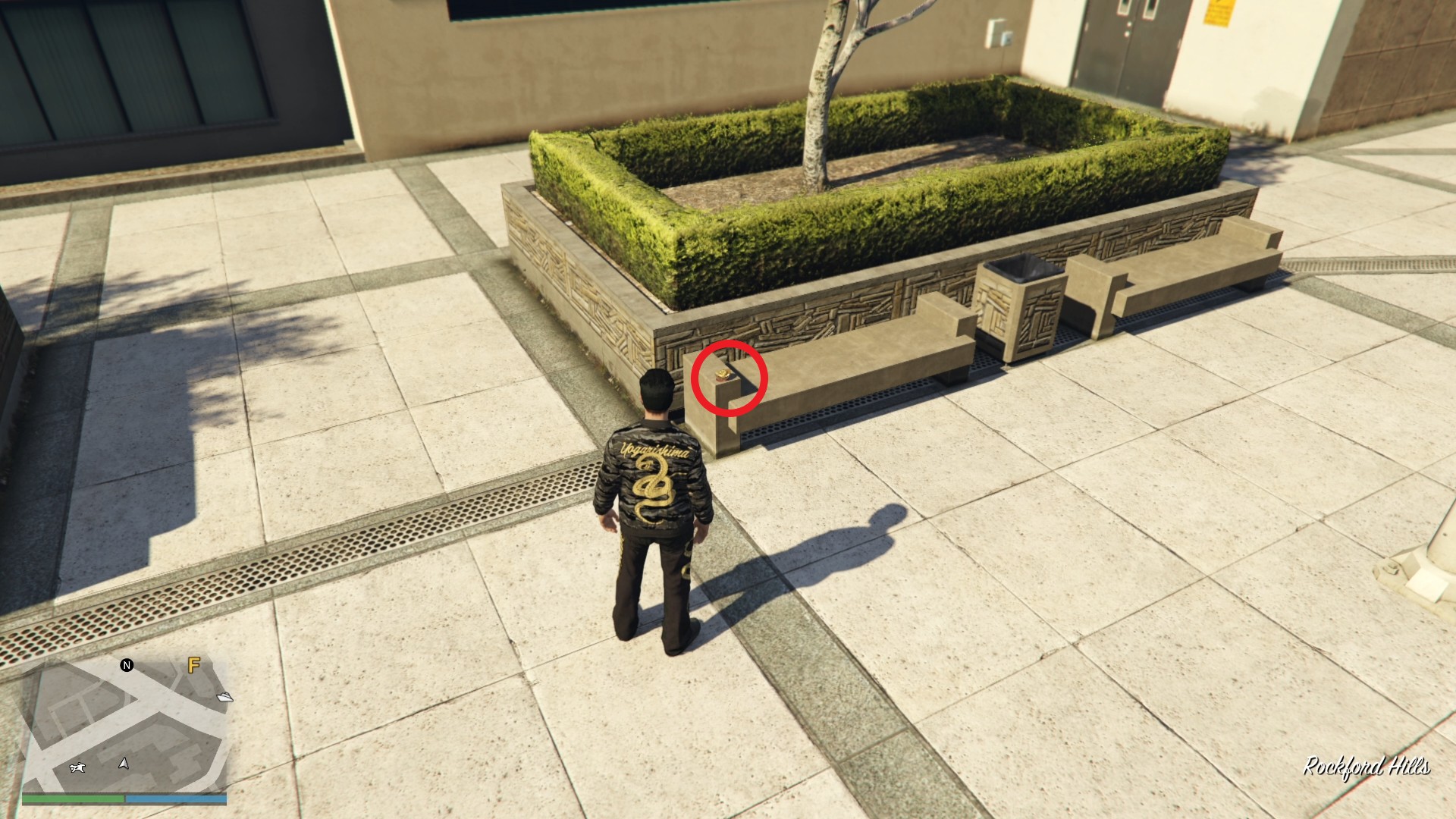 The Yuanbao is on a solid bench by the grass patch decoration.