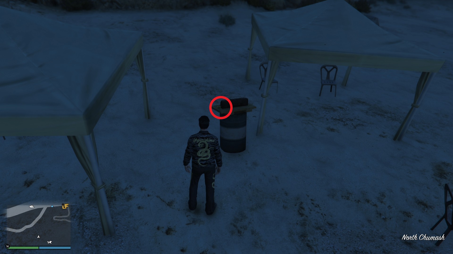 The Yuanbao is on a DIY barbecue grill barrel at the beach near the canopies.