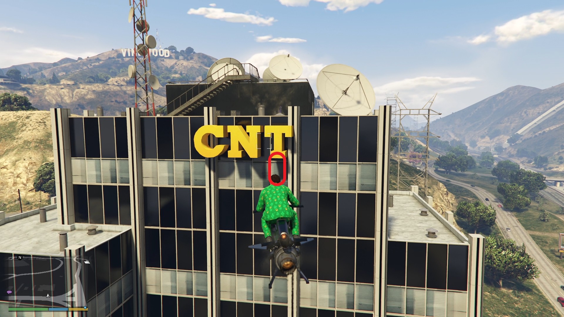 The golden clover will be hanging on the facade of the CNT television network building just below the "T" in East Vinewood.