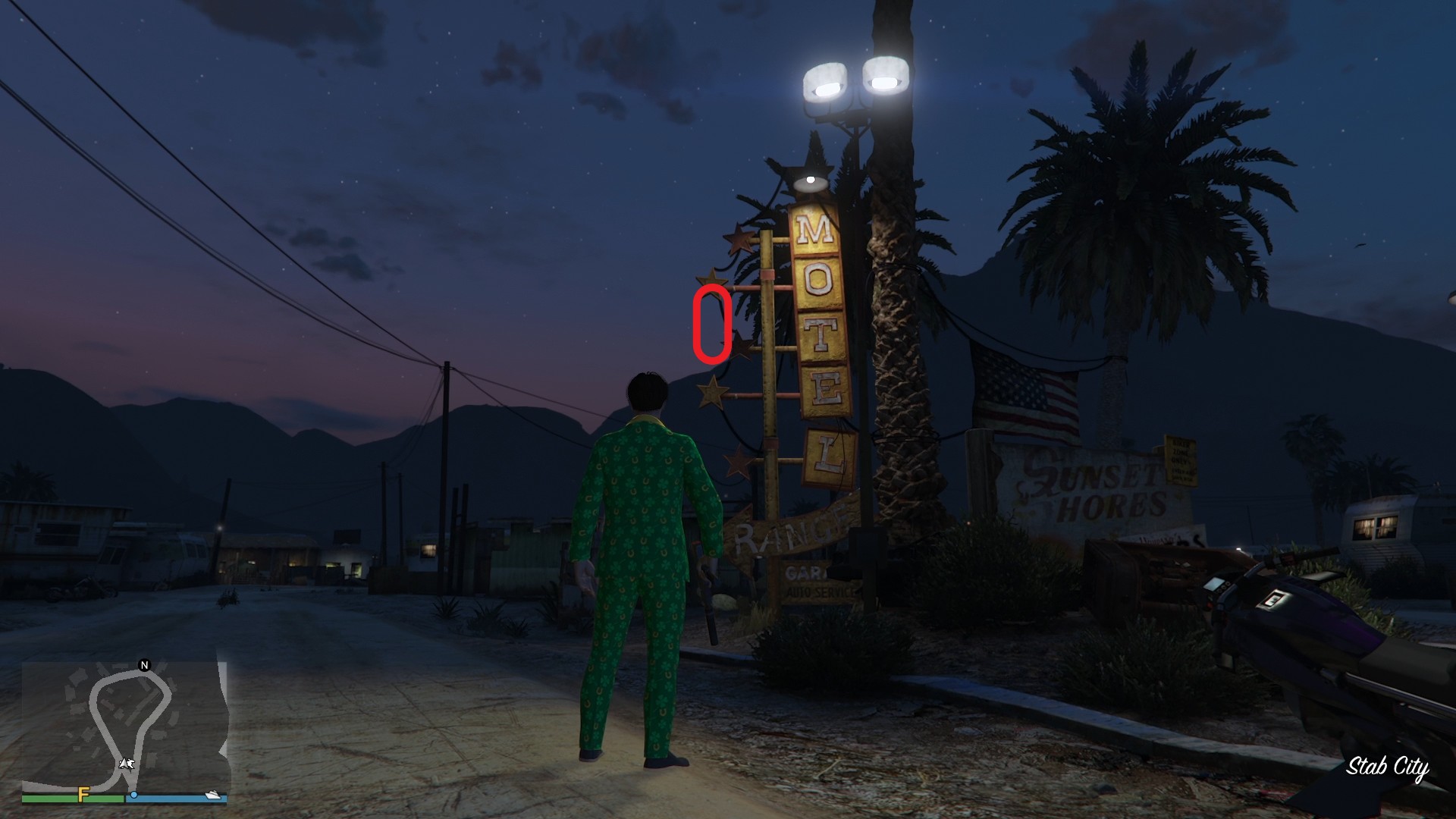 The golden clover will be hanging off the star decoration next to the "O" on the Motel sign right outside Stab City.