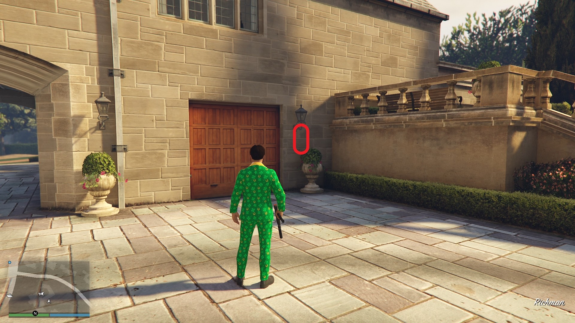 The golden clover will be hanging directly below the wall lamp beside the garage door of a mansion in Richman.