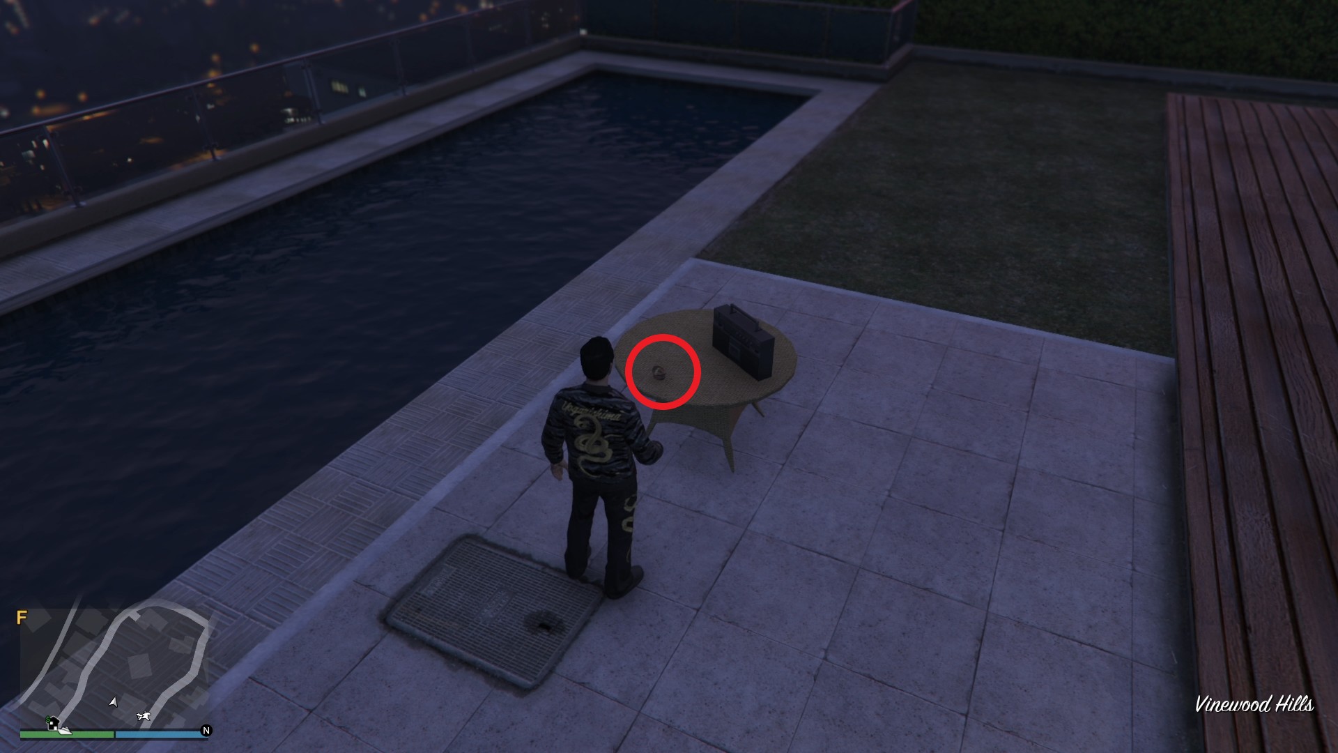 The Yuanbao is on the table by the swimming pool in the backyard of the house.