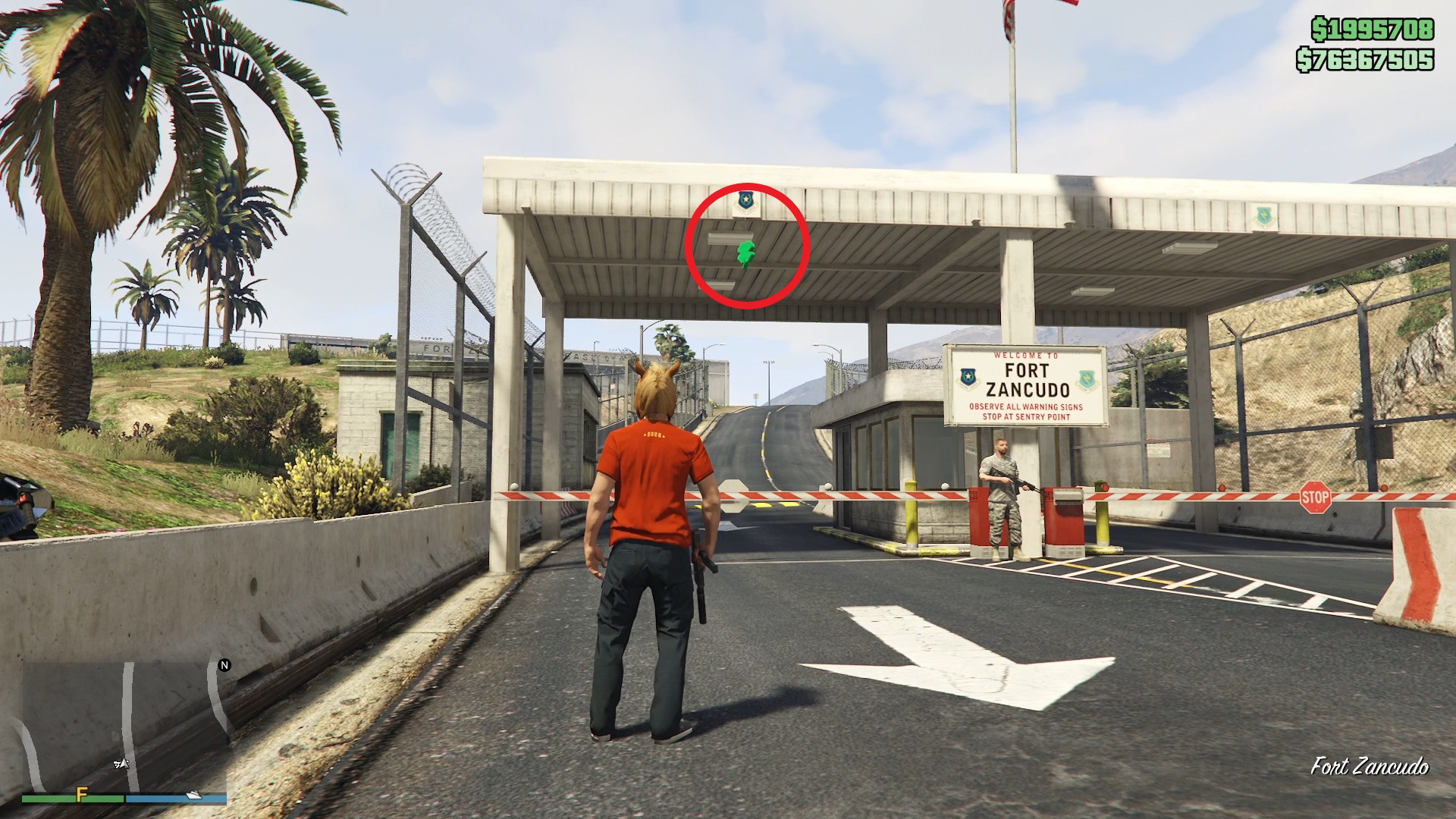 The lucky clover is hanging under the checkpoint canopy at the main entrance gate of Fort Zancudo.