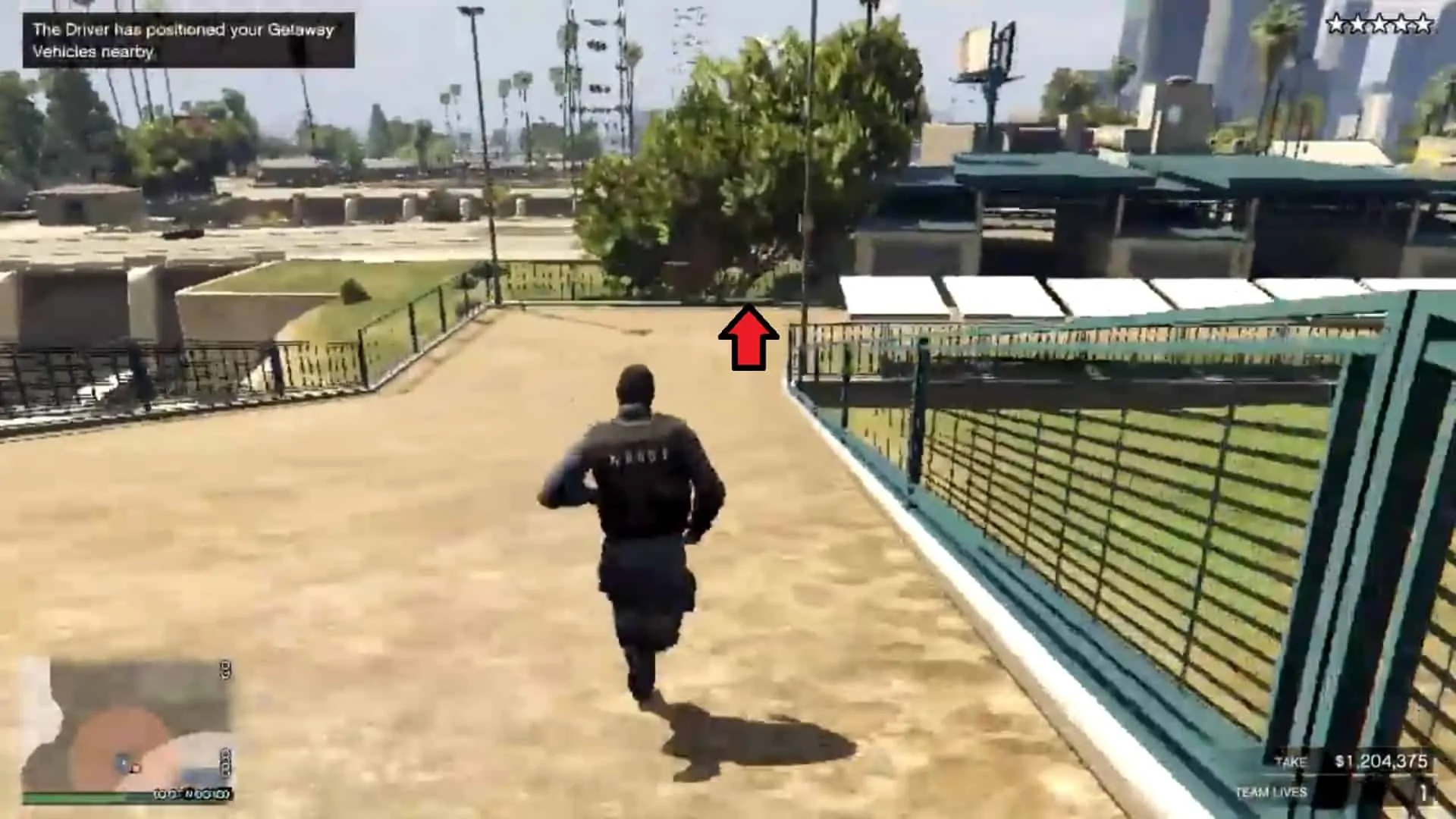 At the end of the right side, descending towards the fence (indicated by a red arrow)