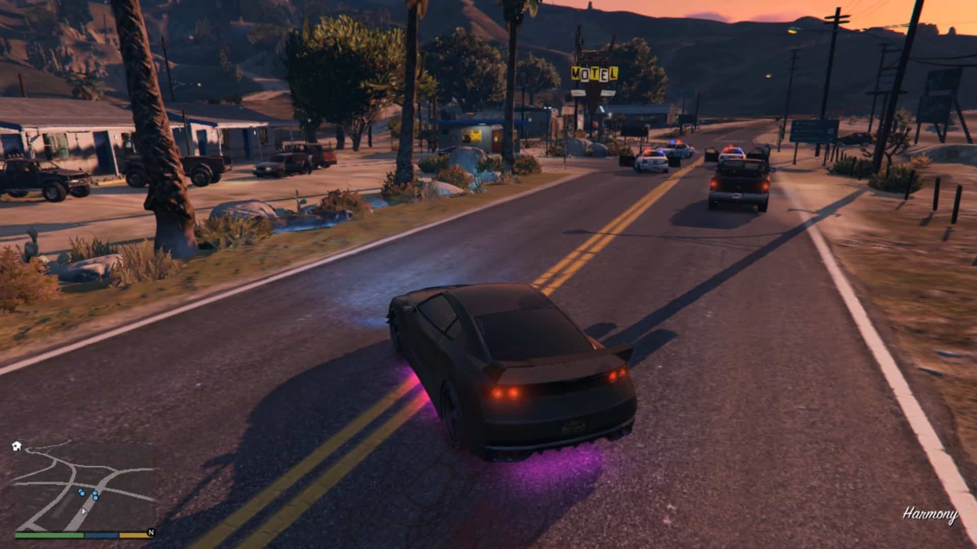 The cop cars in front of the Eastern Motel with cops taking cover behind them as they fight the robbers