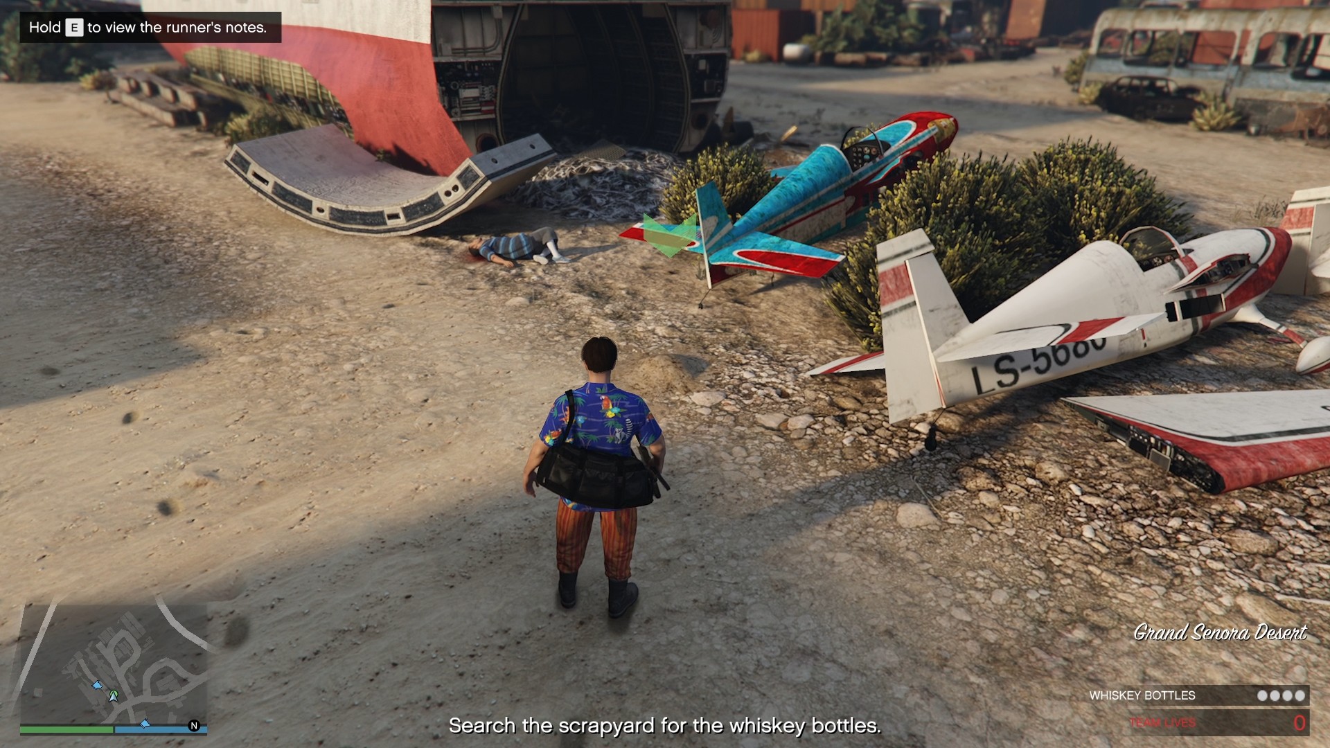 Search the small dirt mound by the blue plane.