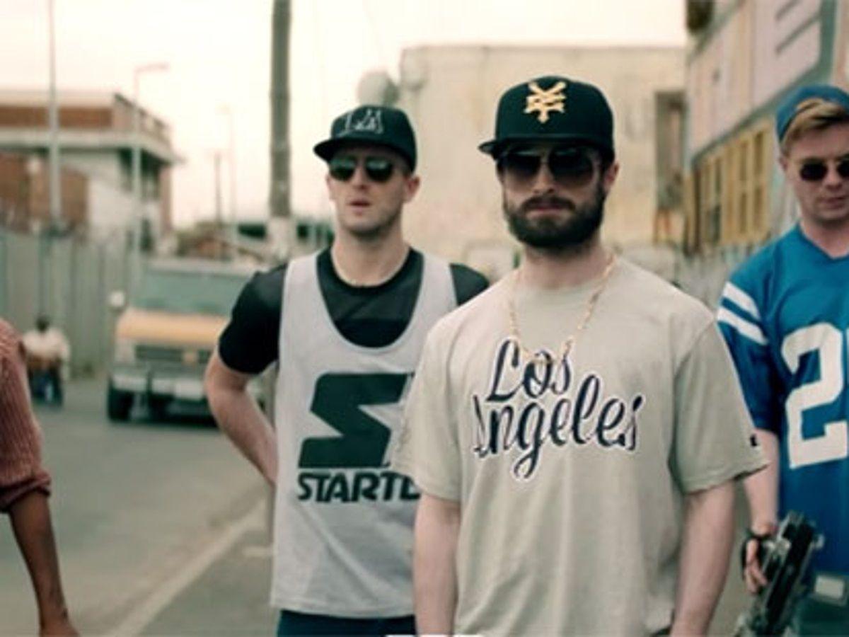 Dan Houser, as portrayed by Ian Keir Attard, along with his brother, Sam Houser, played by Daniel Radcliffe, in the 2015 film, The Gamechangers.