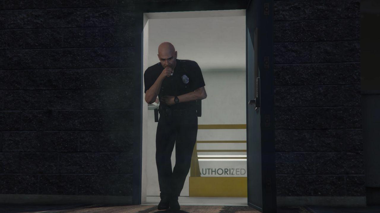 Cop coming out of the police station.