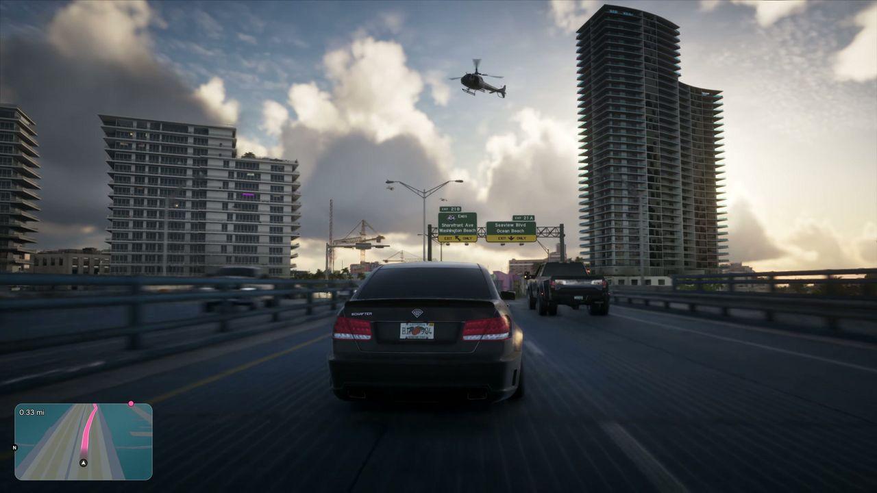 A car heads toward the high-rises of Vice City in late-afternoon light.