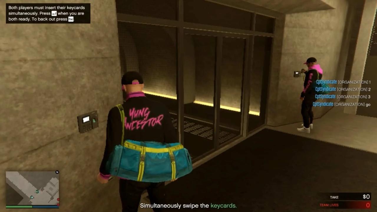 Swiping the keycard simultaneously with your friend to enter the mantrap leading to the vault