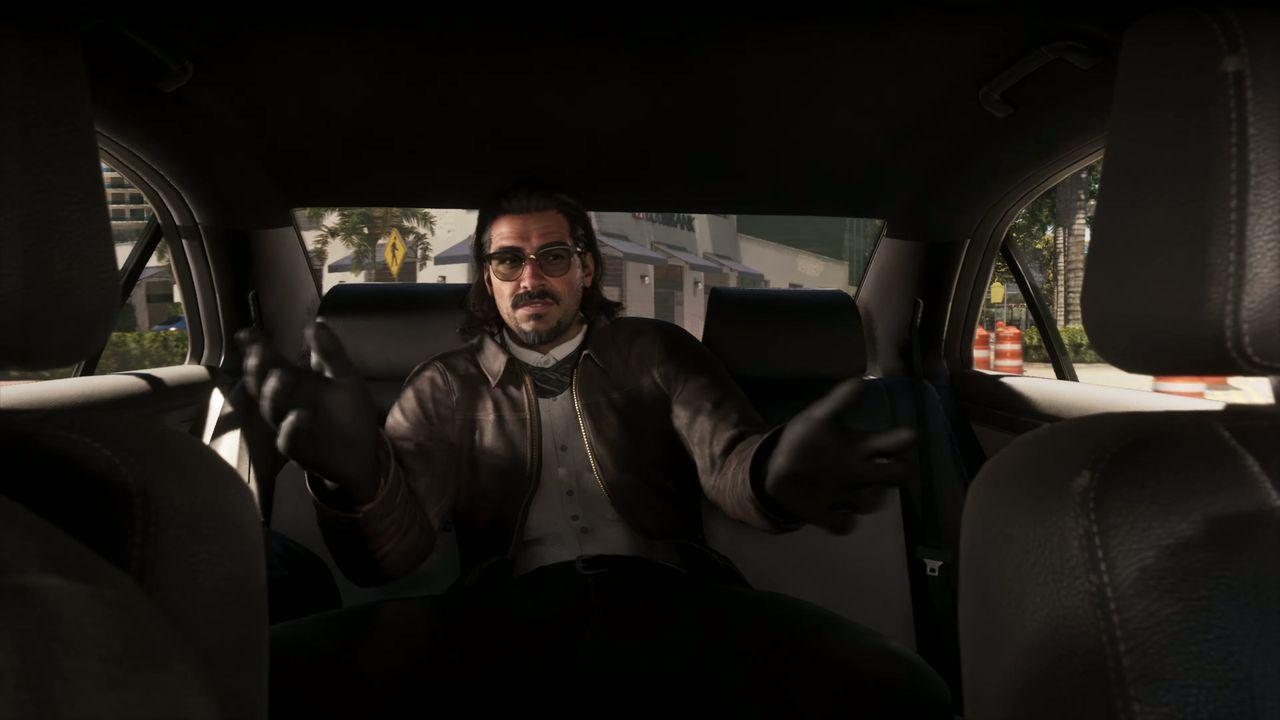 A sharply dressed passenger talks from the back seat.