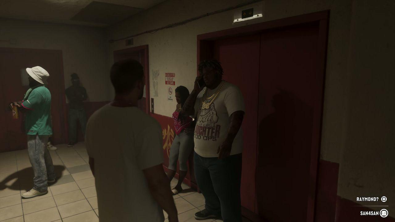 The group moves into a worn apartment corridor.