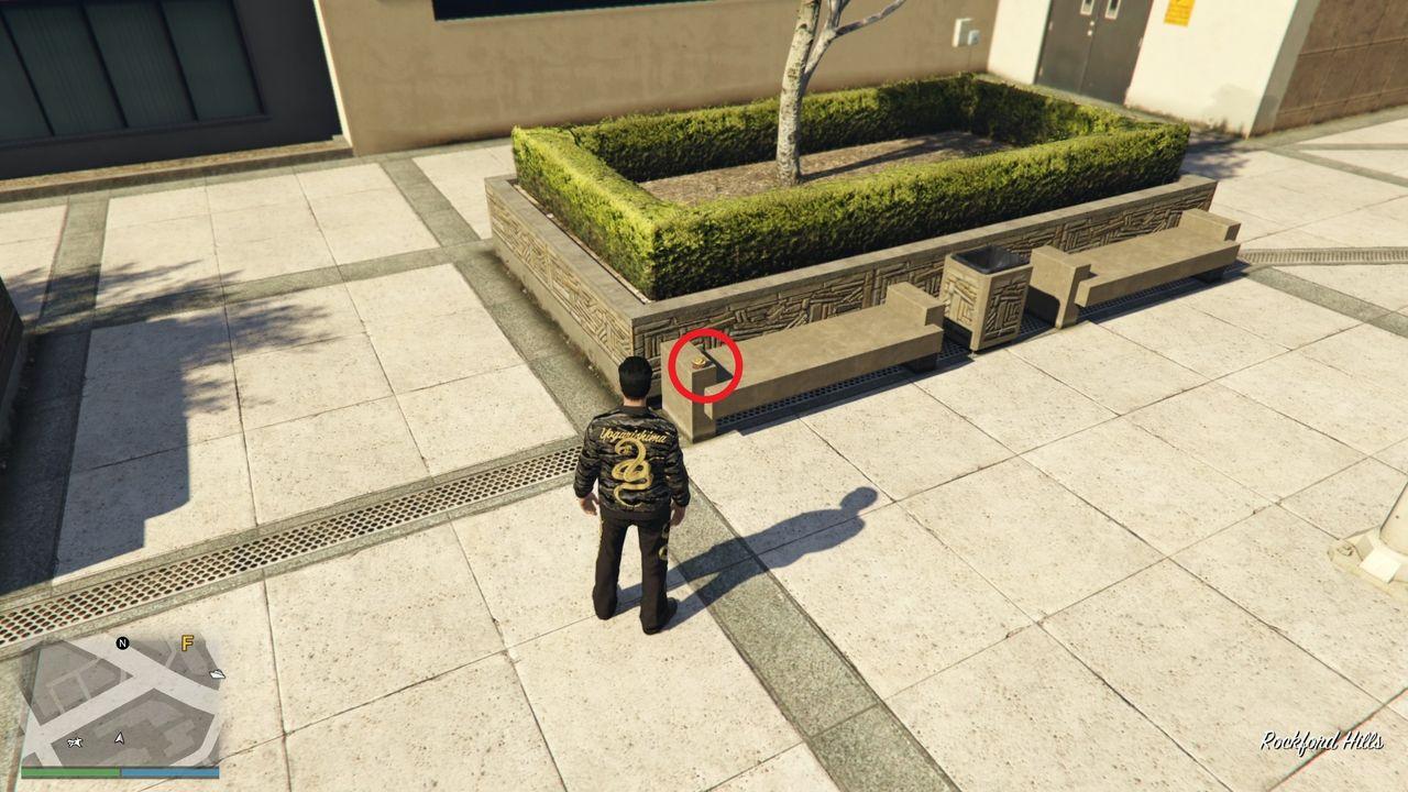 The Yuanbao is on a solid bench by the grass patch decoration.