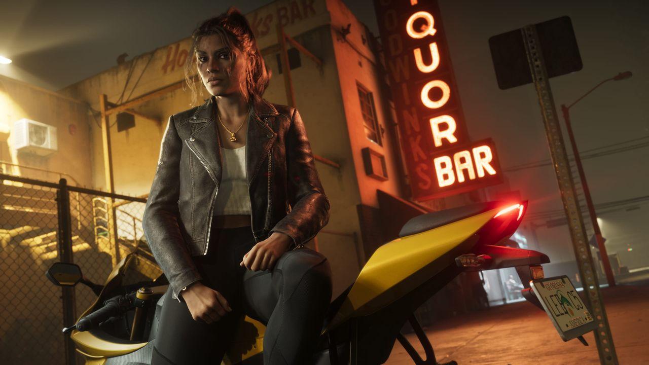 Lucia Caminos sitting on a yellow unidentified motorcycle.