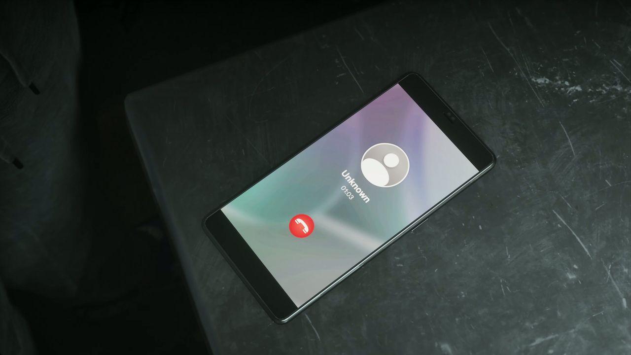 An incoming call interrupts the apartment meeting.
