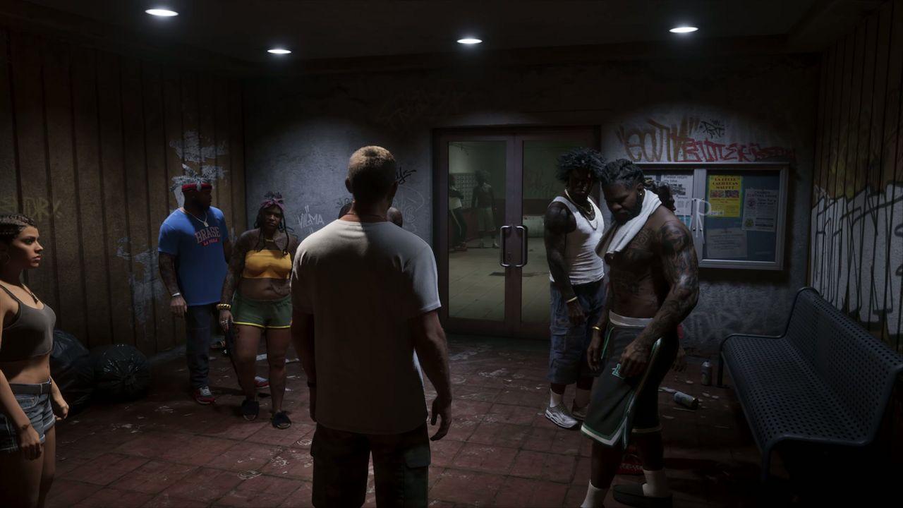 Jason and Lucia enter the lobby as a group gathers near the elevators.