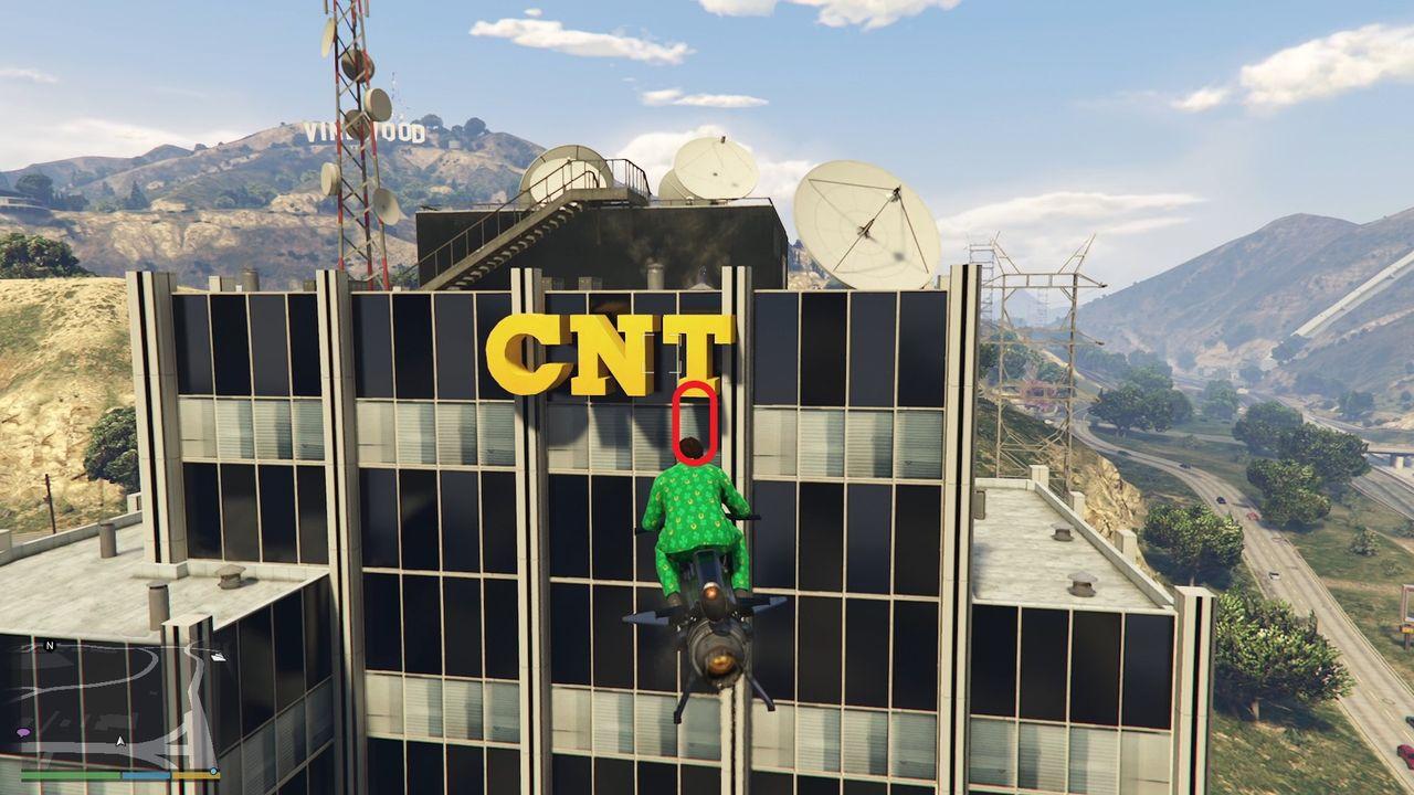 The golden clover will be hanging on the facade of the CNT television network building just below the "T" in East Vinewood.