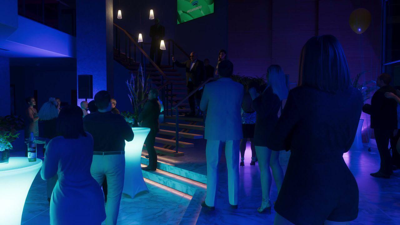 The dance floor fills under deep blue club lighting.