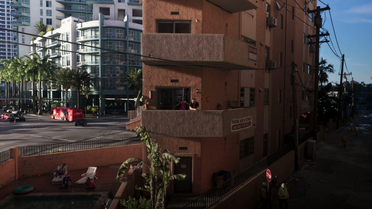 Dense apartment buildings rise above a sunlit Vice City street.