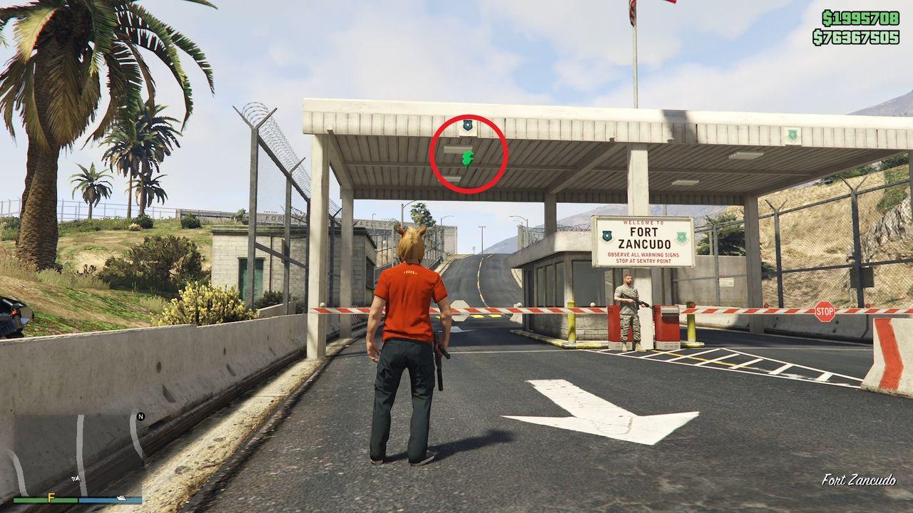 The lucky clover is hanging under the checkpoint canopy at the main entrance gate of Fort Zancudo.