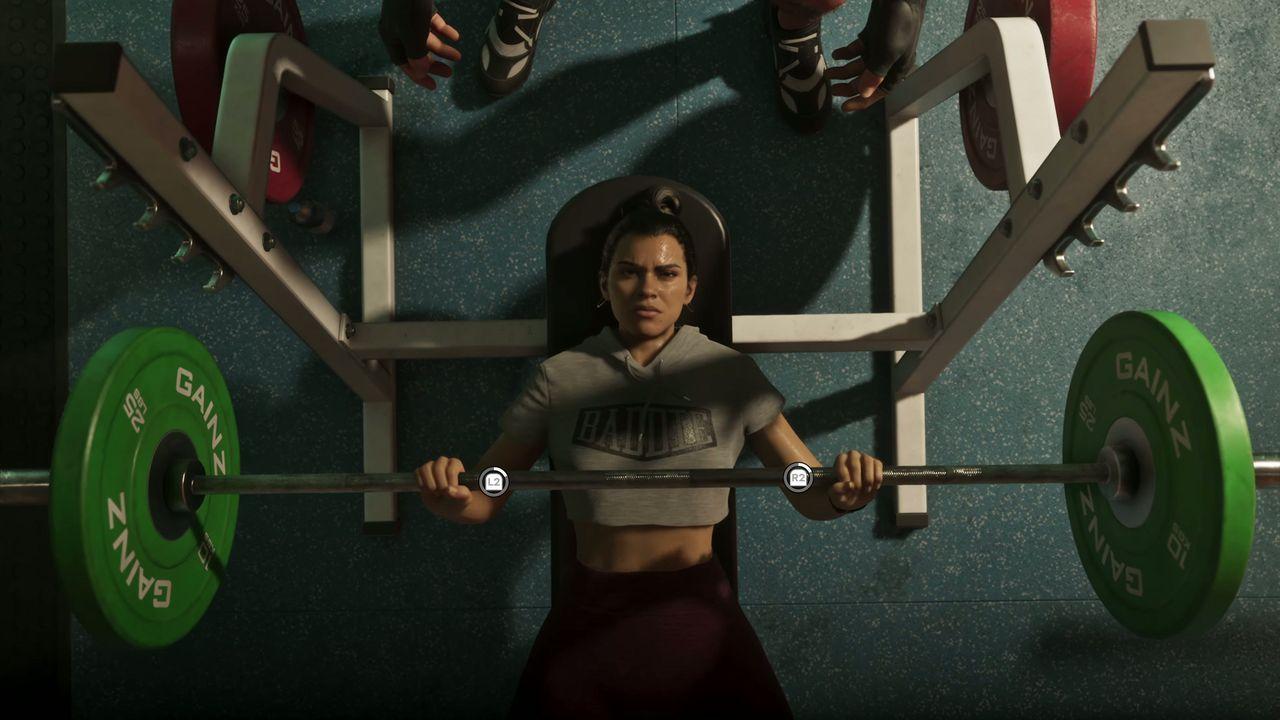 A woman performs a deadlift in a gym.