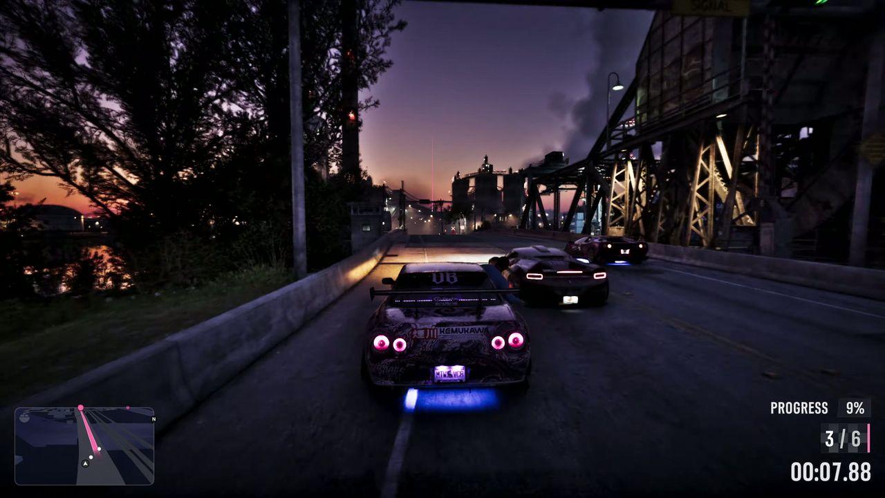 A night race speeds along a road lit by bridges and traffic.