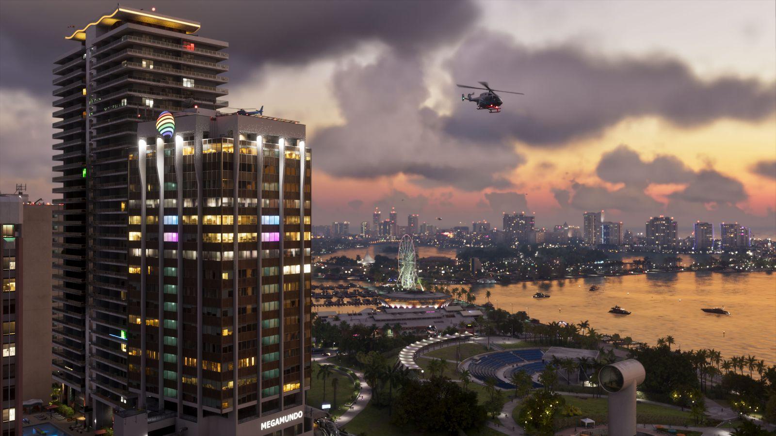 A helicopter crosses the Vice City skyline at sunset.