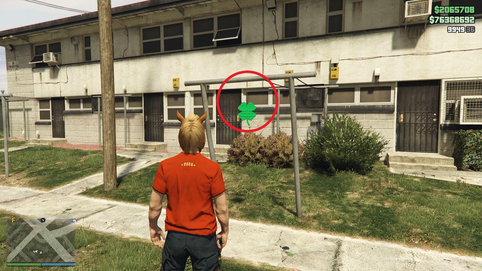 The lucky clover is hanging off a metal drying rack in the front yard of a run-down apartment complex in Rancho.