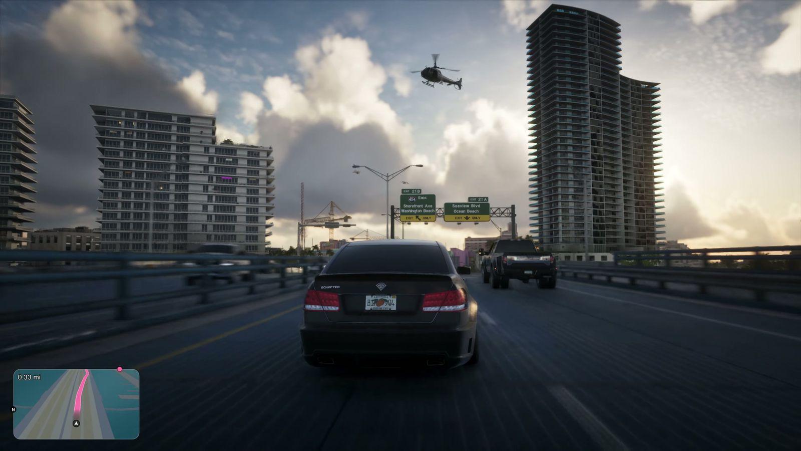 A car heads toward the high-rises of Vice City in late-afternoon light.