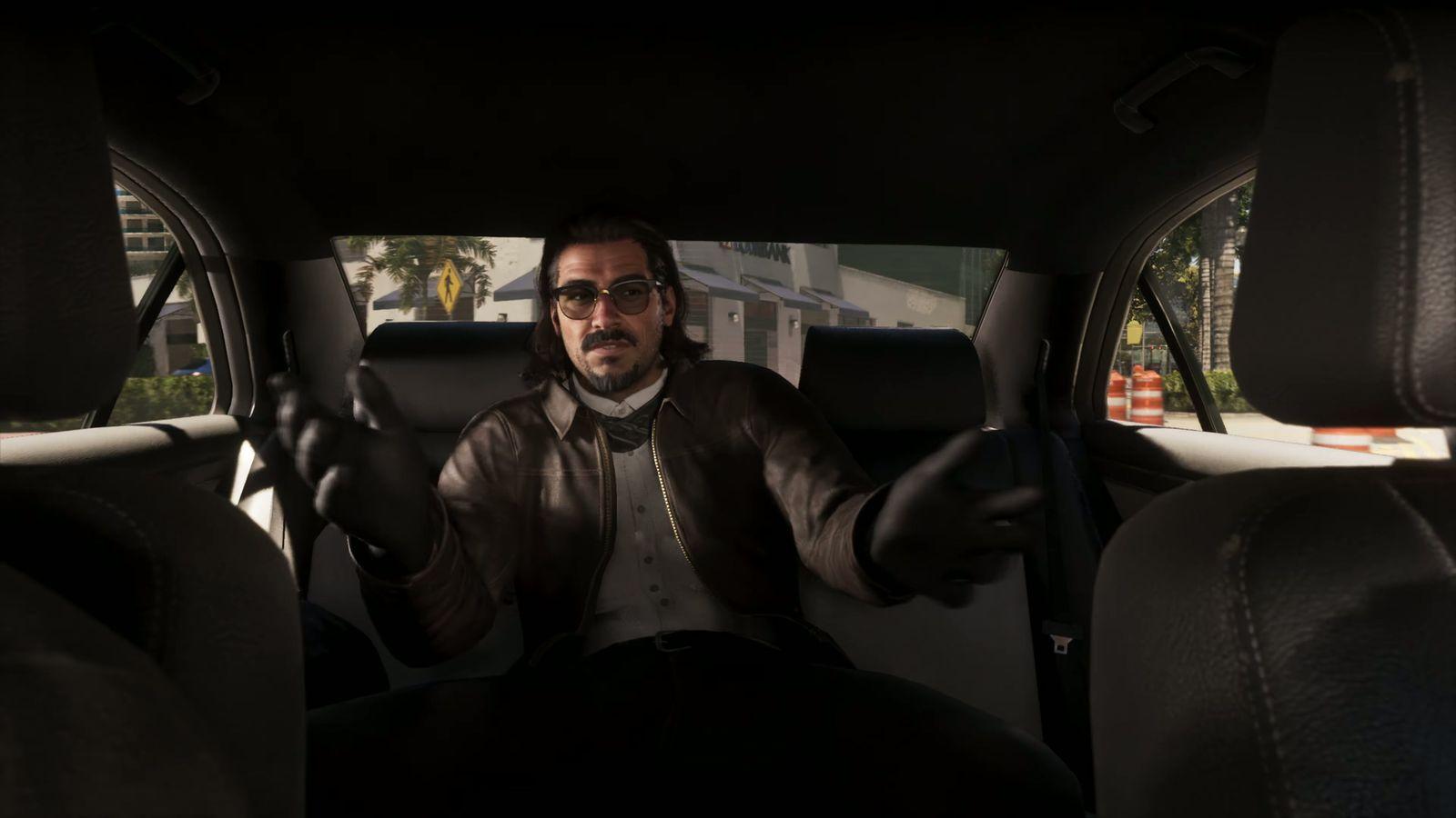 A sharply dressed passenger talks from the back seat.