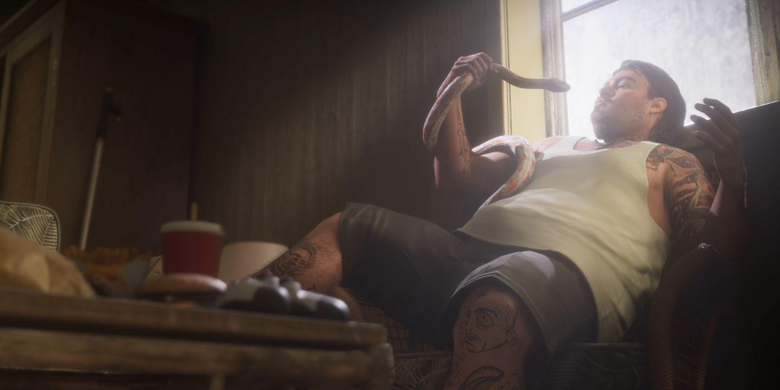 A seated man holds a snake beside a sunlit window.