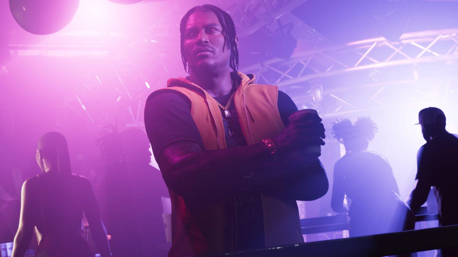 DreQuan Priest in the club with a drink in hand.