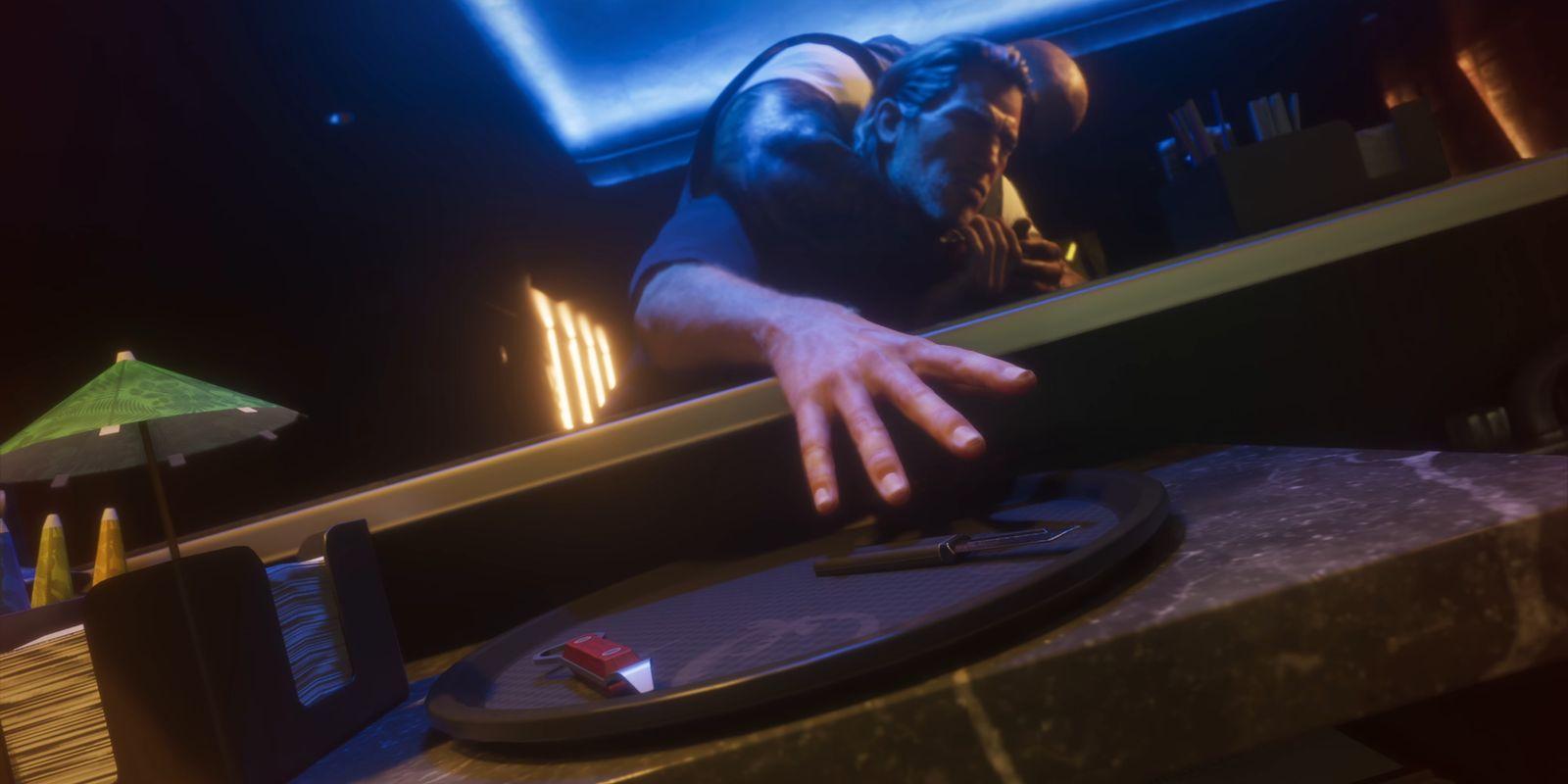 A man is held against a bar as he reaches toward a handgun.