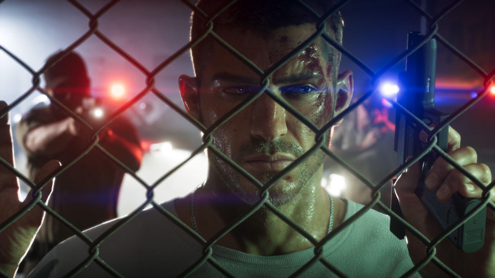 Jason looks through a chain-link fence as police lights flash behind him.