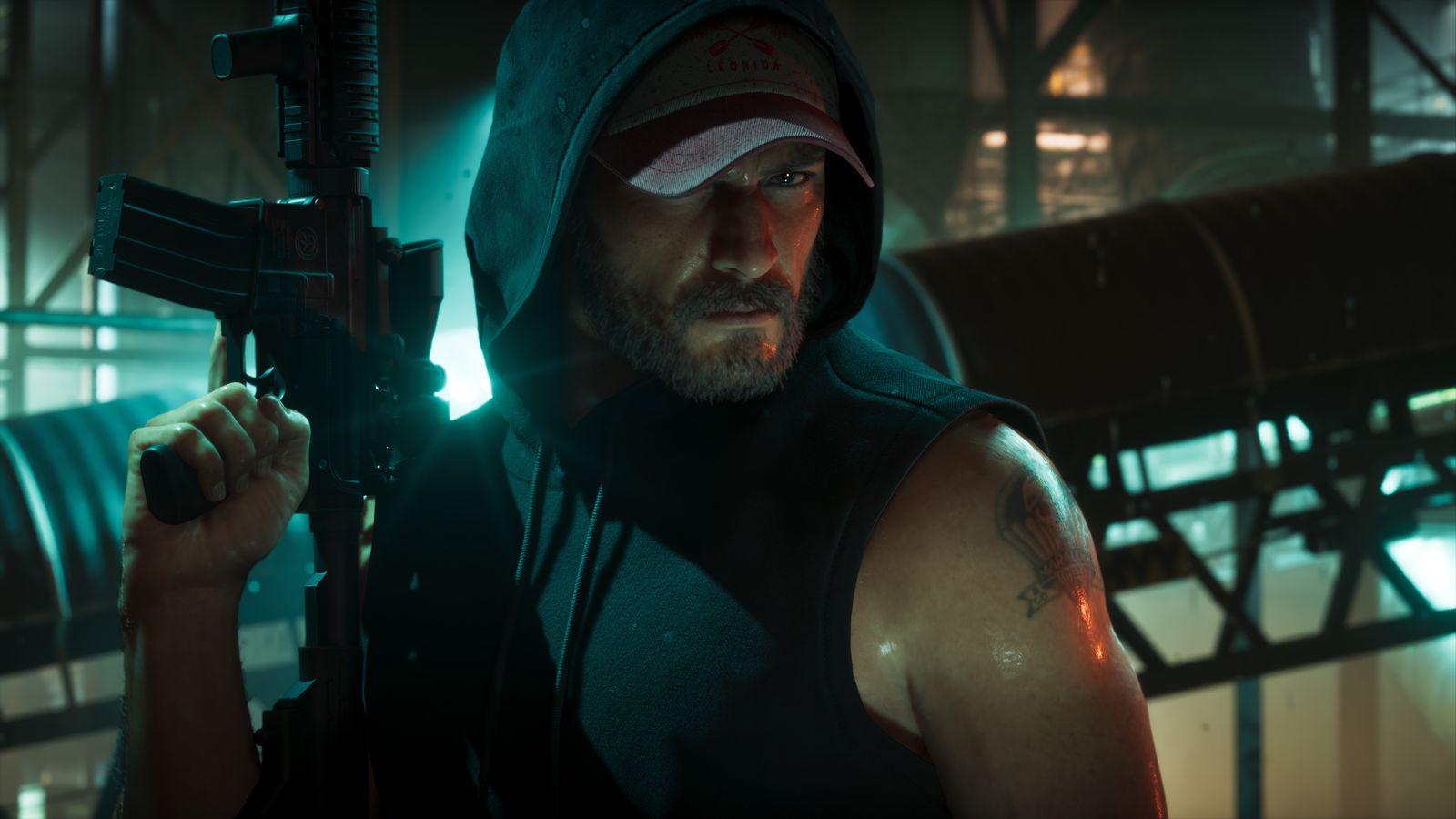 A hooded Jason carries a handgun through a dim industrial building.