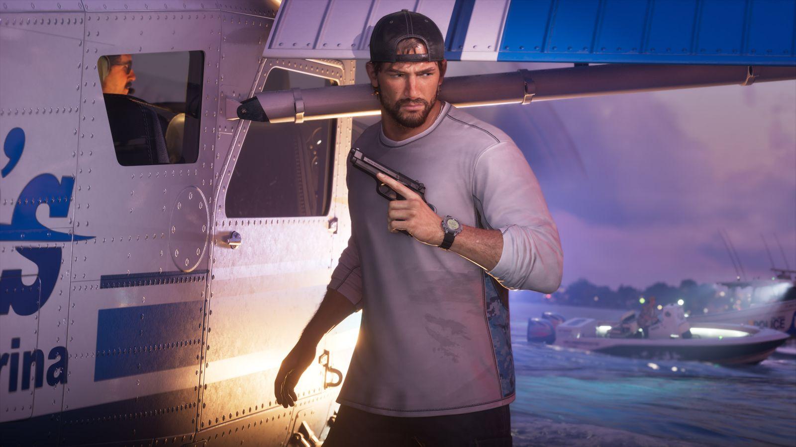 Jason holds a handgun beside an ambulance at night.