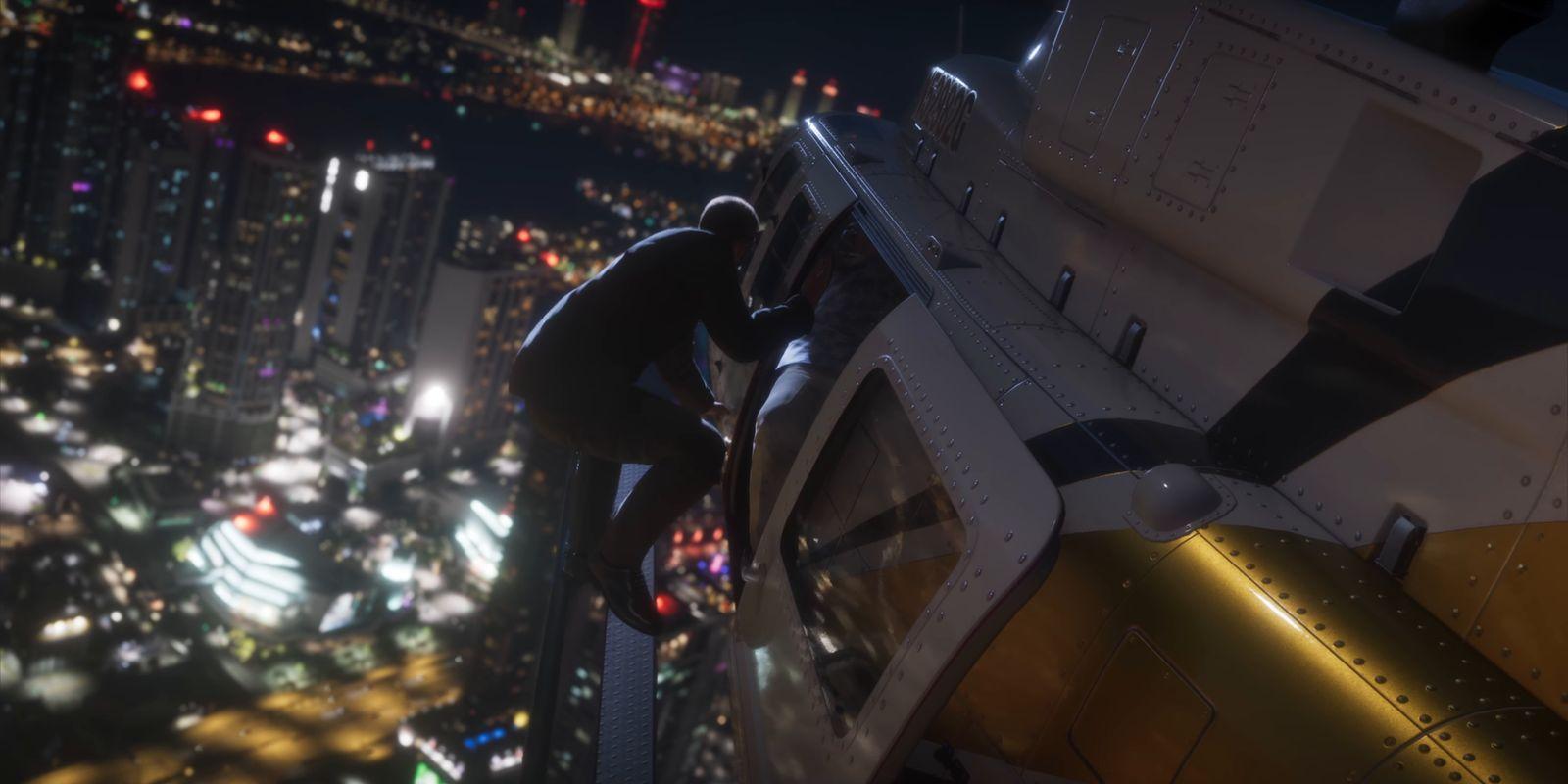 A man clings to the outside of a helicopter above the city at night.