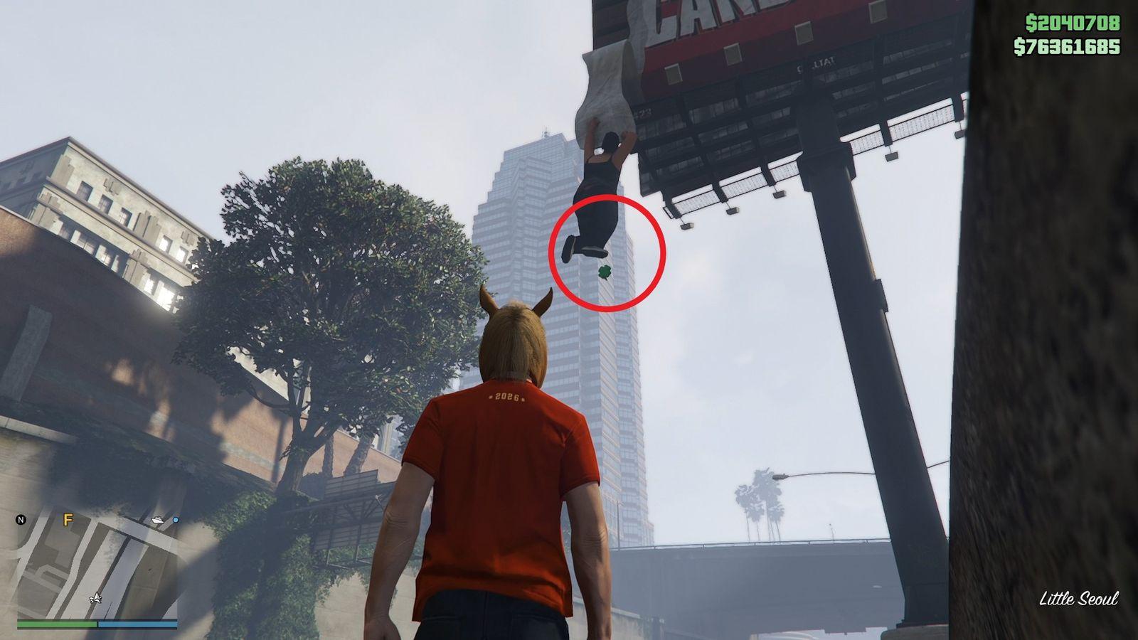 The lucky clover is hanging on the dangling man statue attached to the Candybox billboard on Del Perro Freeway in Little Seoul.