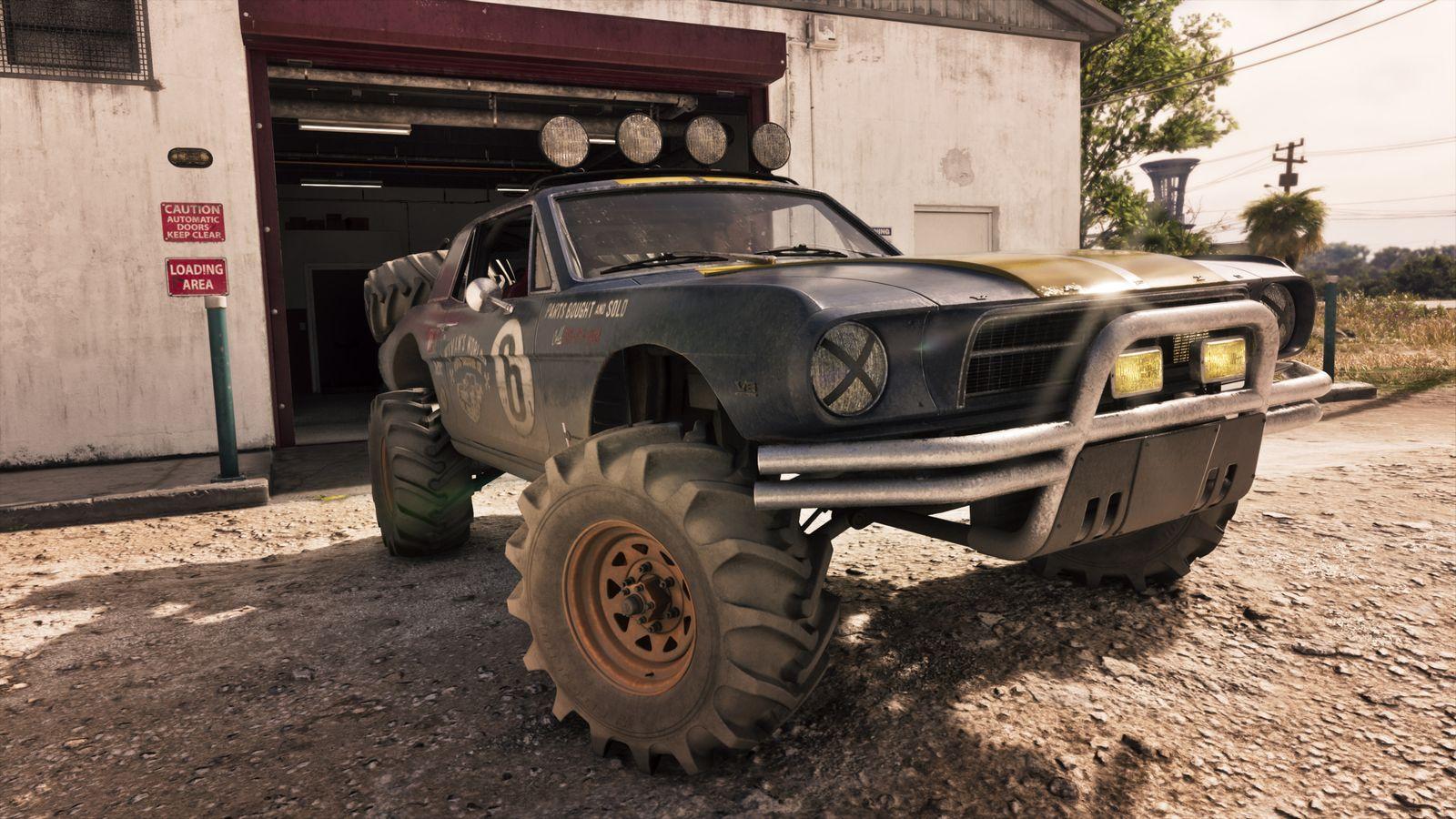 The buggy outside a garage, with its raised body and racing graphics in view.
