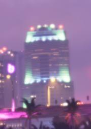 Heath Tower glows above Downtown Vice City in layered bands of color.