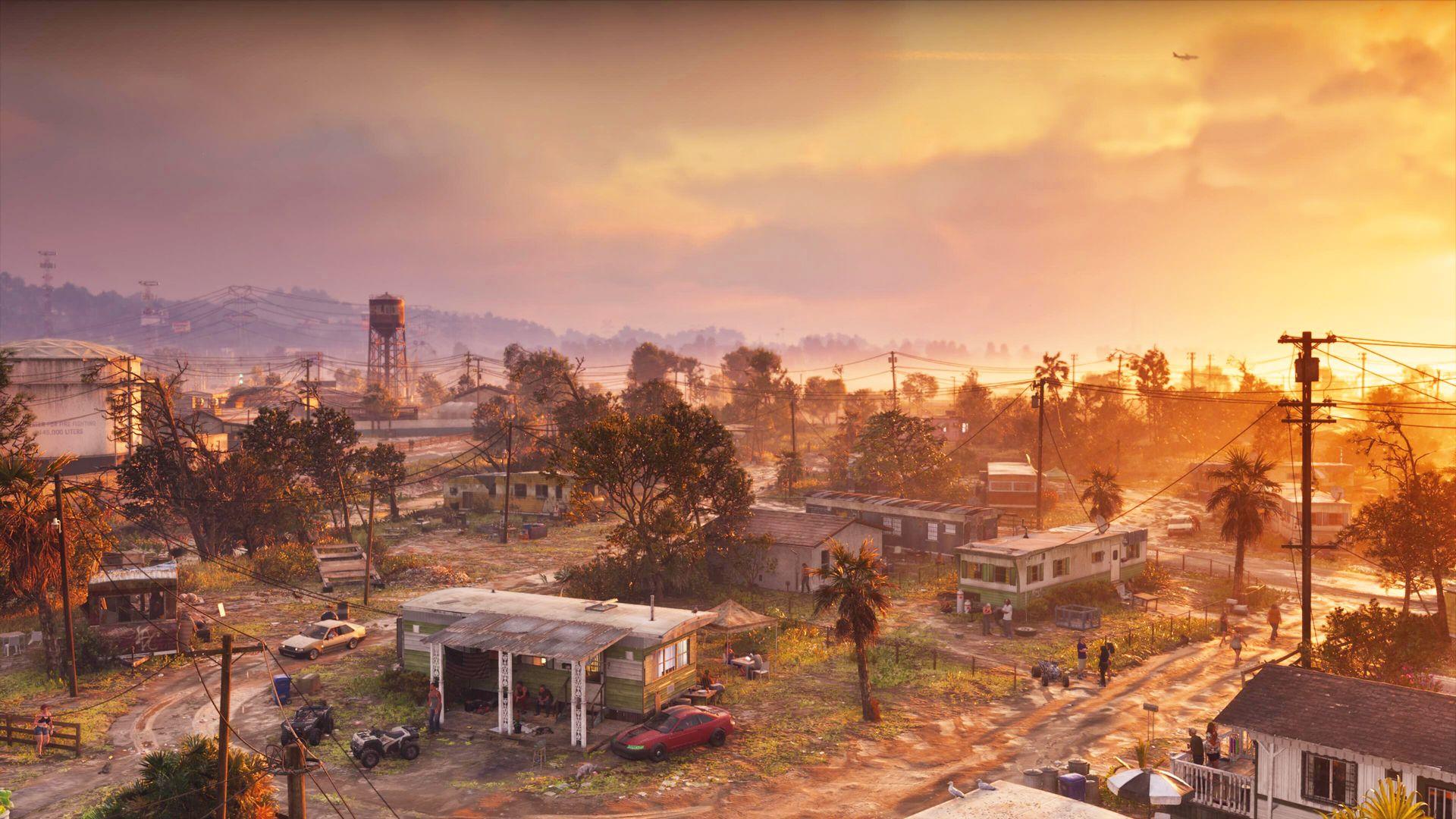 Low buildings, trees and utility poles stretch across a neighbourhood in the evening light.