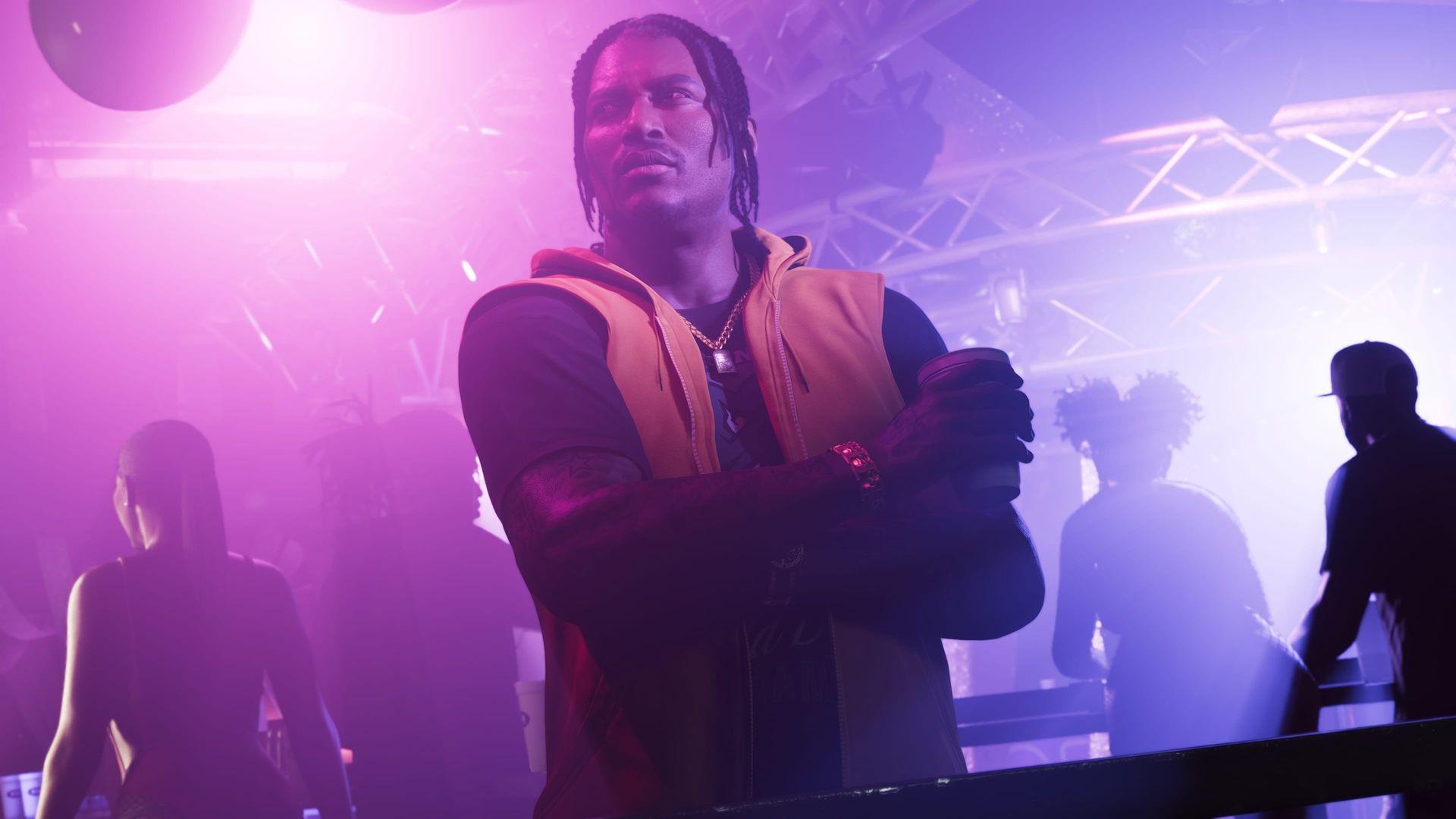 DreQuan Priest in the club with a drink in hand.