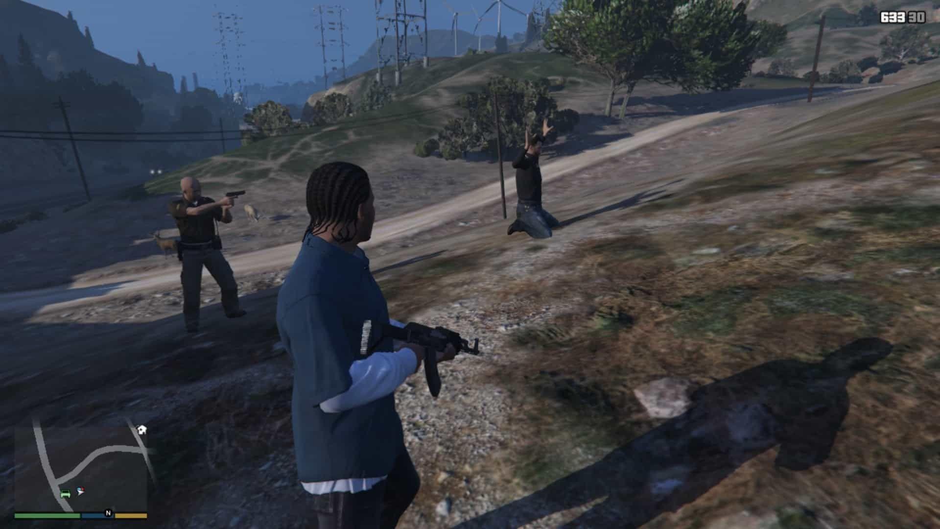 Cop holding the criminal at gunpoin