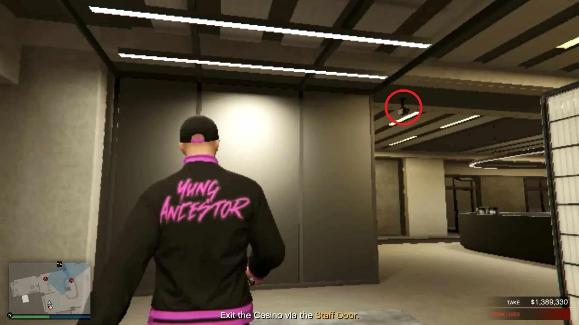 The security camera (circled in red) right outside the surveillance room when you exit through the back door