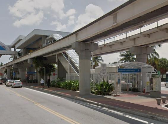 The real Metromover station uses the same elevated track and compact entrance.