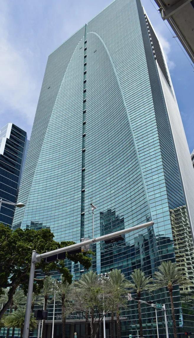 Brickell Arch combines a blue-glass face with a pale structural frame.