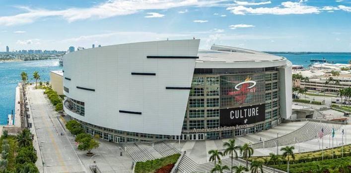 Kaseya Center beside Biscayne Bay, with its curved shell and broad frontage.