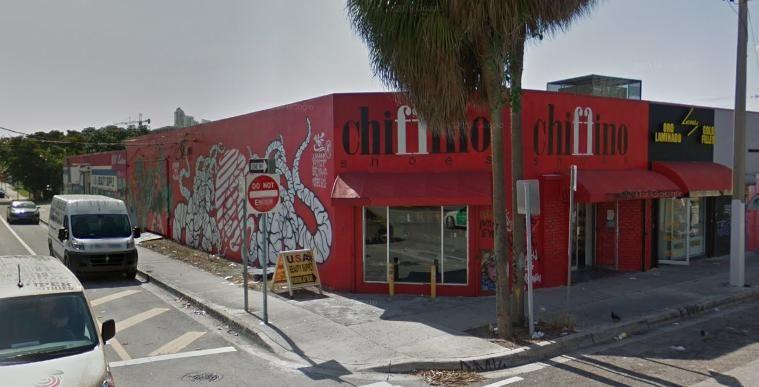 The real building uses a similar mural across the same low corner facade.